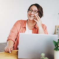 Woman with glasses talking on the phone