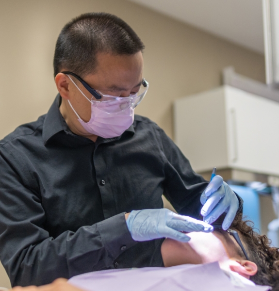 Woman in dental chair smiling at her orthodontist