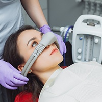 Woman wearing a nasal mask at the dentist’s office